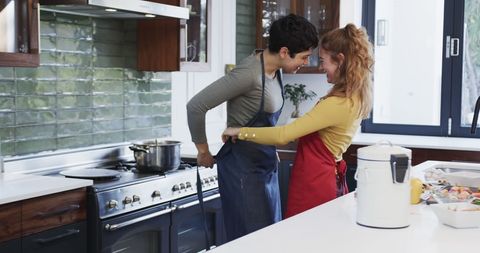 Happy Couple Embracing and Preparing to Cook in Cozy Kitchen - Download Free Stock Images Pikwizard.com