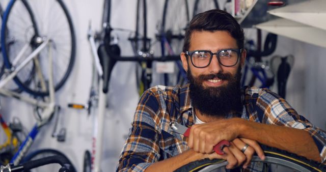 Smiling Bearded Bicycle Mechanic in Workshop with Bikes - Download Free Stock Images Pikwizard.com