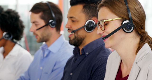 Smiling Customer Service Representatives Using Headsets in a Call Center - Download Free Stock Images Pikwizard.com