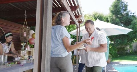 Diverse senior group enjoying outdoor garden party celebration