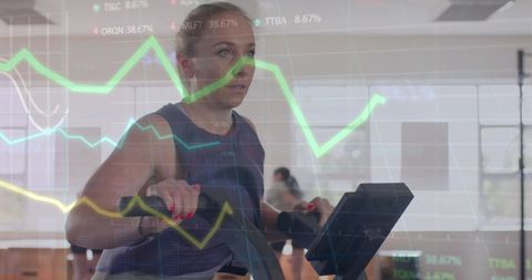 Woman Training on Elliptical with Digital Graph Overlay