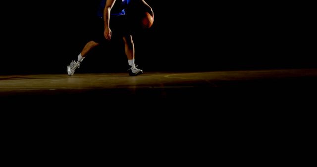 Basketball Player Dribbling Ball on Dark Court - Download Free Stock Images Pikwizard.com