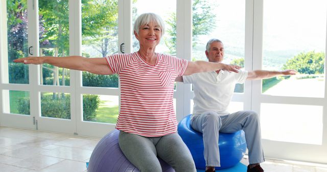 Senior Couple Exercising on Stability Balls in Bright Room - Download Free Stock Images Pikwizard.com