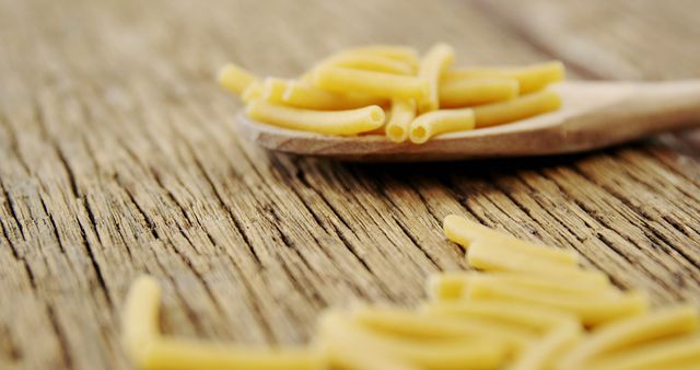 Uncooked Pasta on Wooden Surface with Rustic Spoon - Download Free Stock Images Pikwizard.com