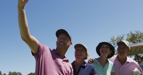 Seniors Enjoying Golf Course Selfie under Clear Blue Sky