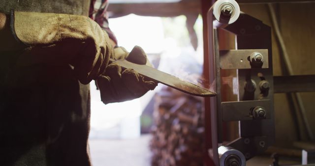 Person Sharpening Knife in Workshop with Industrial Equipment - Download Free Stock Images Pikwizard.com