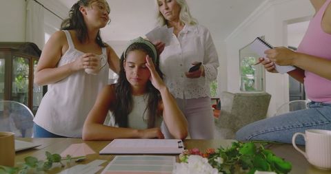 Women collaborating on wedding planning at table