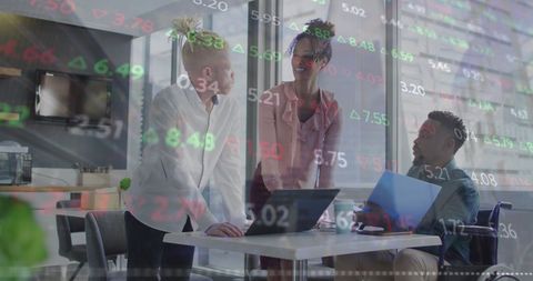 Diverse Business Team Analyzing Market Data in Modern Office