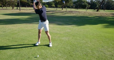 Golfer Swinging Club on Sunny Golf Course - Download Free Stock Images Pikwizard.com