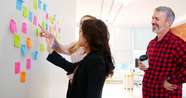 Diverse Team Collaborating on Project with Colorful Sticky Notes - Download Free Stock Images Pikwizard.com