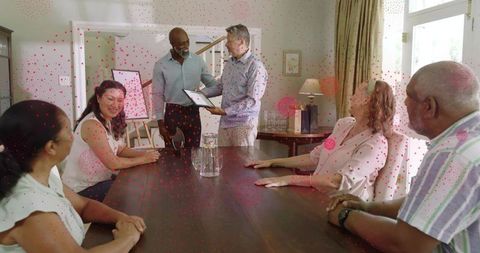 Presenting award at home dining table, friends gathering and celebrating recognition