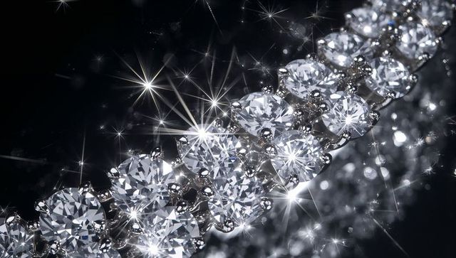 Sparkling diamond tennis bracelet macro, brilliant-cut gems on white-metal with starburst