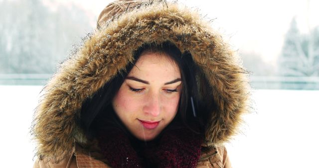 Woman in Winter Coat with Fur Hood Enjoying Snowy Day Outdoors - Download Free Stock Images Pikwizard.com