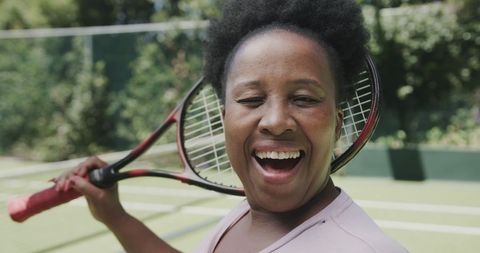Joyful Senior African American Woman with Tennis Racket