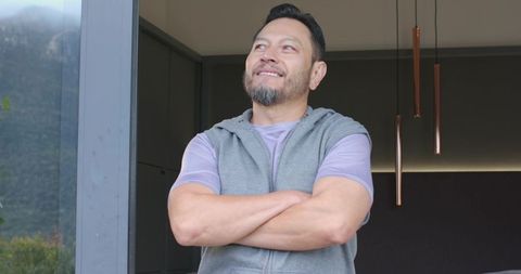 Serene gazing out glass door in modern minimalist home