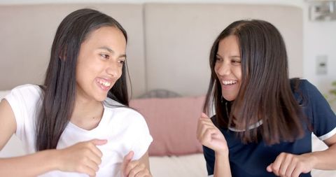 Happy Teenage Girls Dancing and Laughing at Home