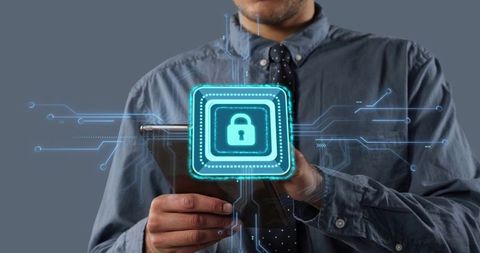Professional holding tablet projecting holographic lock and circuit lines for cybersecurity