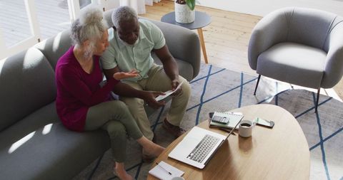 Senior Couple Discussing Finances in Living Room