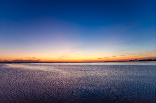 Serene Ocean Sunset with Calm Waters and Colorful Sky - Download Free Stock Photos Pikwizard.com