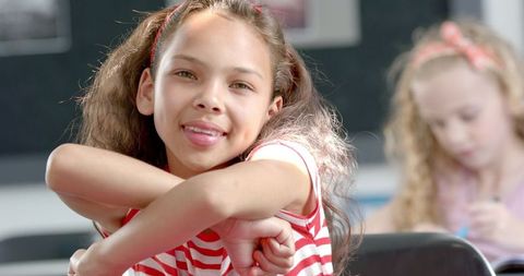 Happy Girl Smiling and Relaxing in Classroom