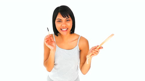Smiling Woman Applying Makeup with Mirror and Brush