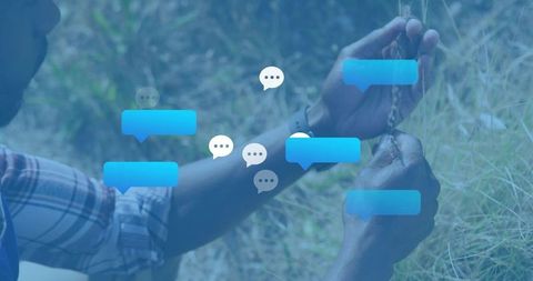 Inspecting dried grass stalks in meadow with blue chat bubbles overlay