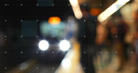 Blurry subway train arriving with bright headlights