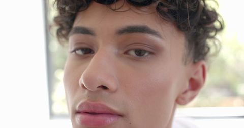Young Man with Curly Hair in Bright Natural Light