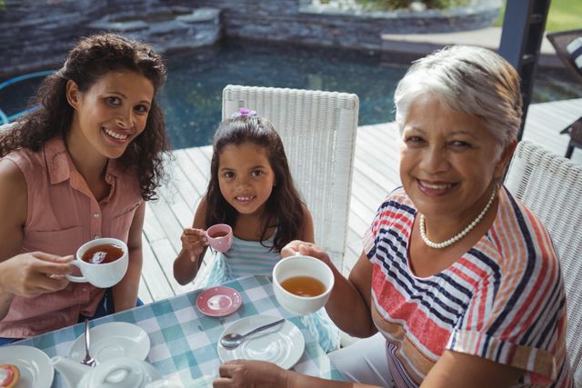 Three Generations of Women Enjoying Tea Together - Download Free Stock Photos Pikwizard.com