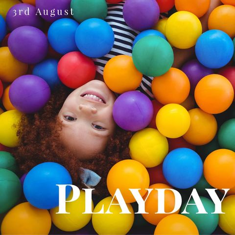 Joyful child playing amidst colorful plastic balls for playday