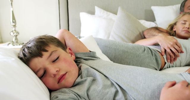 Happy Mixed-Race Family Peacefully Sleeping in Bed Together - Download Free Stock Images Pikwizard.com