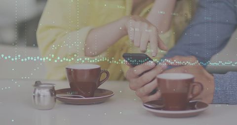 Couple interacting with smartphone and digital data overlay
