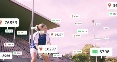 Crouching female soccer player holding ball with ar stat overlays by stadium stands