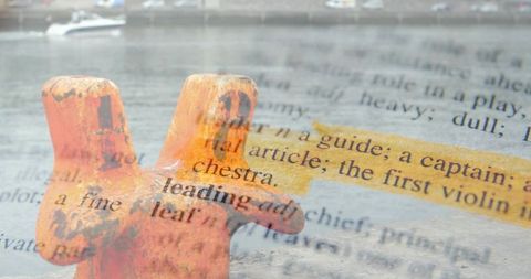 Rusted harbor cleat with book text overlay and yellow highlight double exposure