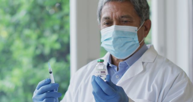 Doctor Preparing COVID-19 Vaccine Injection Wearing Mask and Gloves - Download Free Stock Images Pikwizard.com