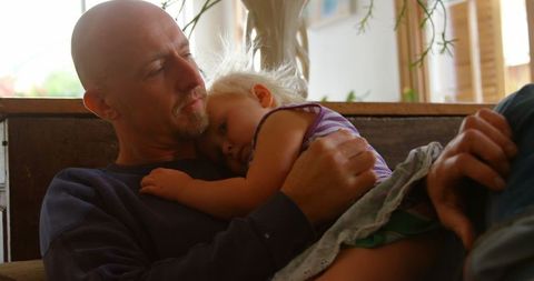 Caucasian Father Comforting Daughter on Couch at Home