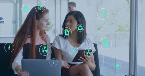 Colleagues Discussing Sustainability Strategies in Modern Office