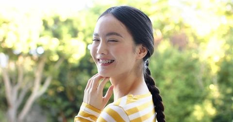 Asian Woman Smiling in Sunny Backyard Garden