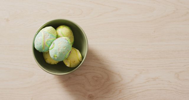 Image of decorated colorful easter eggs in bowl on a wooden surface - Download Free Stock Photos Pikwizard.com