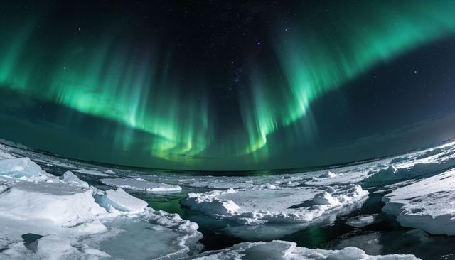 Northern lights dancing over frozen arctic seascape with glowing green aurora reflection