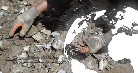 Hands sorting e-waste pieces in recycling yard with global graphic
