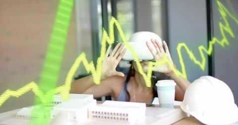 Architect Wearing VR Headset Interacting with Futuristic Graph in Modern Office