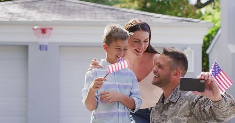 Returning Soldier Captures Joyful Family Homecoming with American Flags - Download Free Stock Images Pikwizard.com