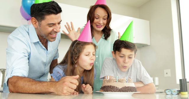 Father lighting candles on birthday cake for his son at home in the dining room - Download Free Stock Photos Pikwizard.com