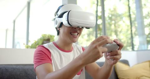 Excited college student gaming in virtual reality