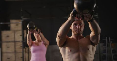 Focused Athletes Engaging in Kettlebell Training at Gym