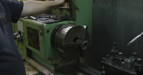 Factory Worker Operating Machine in Industrial Warehouse