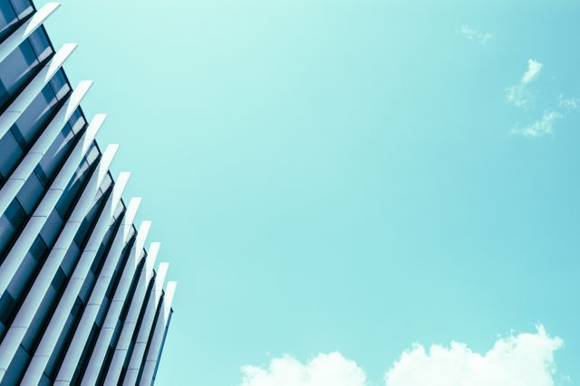 This image is perfect for websites focused on modern architecture and design. It could be used in blogs or articles discussing urban development, contemporary structures, or corporate buildings. The clear sky and minimalistic style add a clean, professional look that may appeal to businesses and architects accessing stock photos.