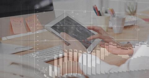 Female hands tapping tablet and analyzing financial charts with keyboard and sticky notes