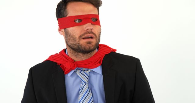 A Caucasian man appears in a business suit with a red blindfold, suggesting a concept of business uncertainty or lack of direction. His puzzled expression enhances the theme of being metaphorically 'in the dark' about business decisions or future prospects.